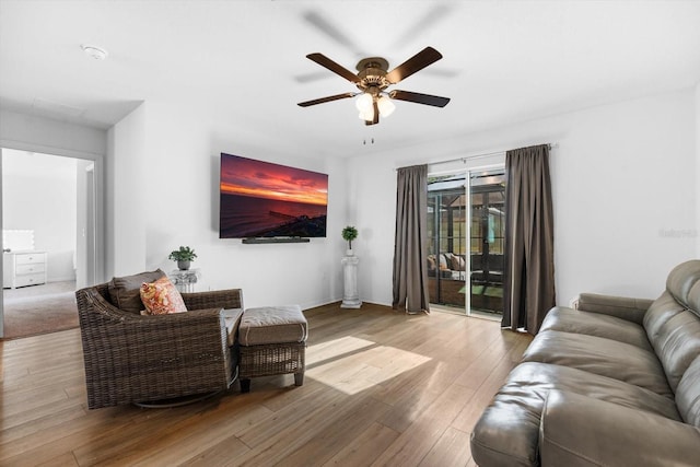 living room featuring ceiling fan and light hardwood / wood-style flooring