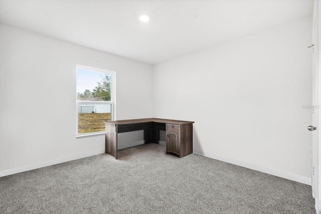 unfurnished office featuring light colored carpet