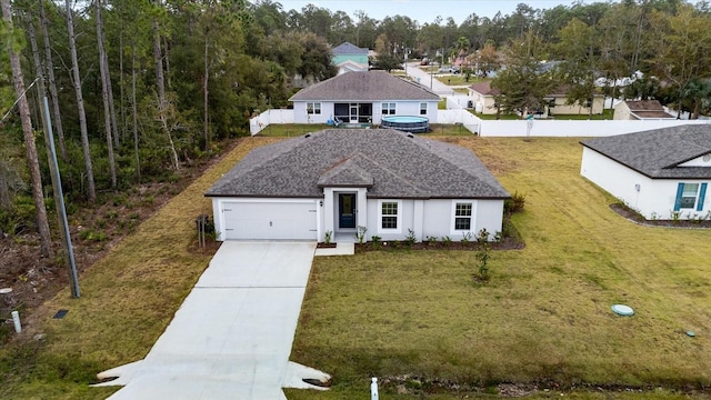 view of front of home featuring a garage and a front yard