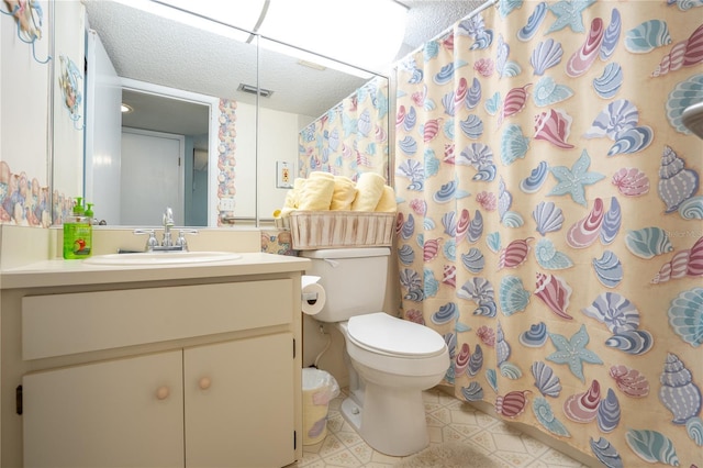 bathroom featuring vanity, a shower with curtain, tile patterned flooring, toilet, and a textured ceiling