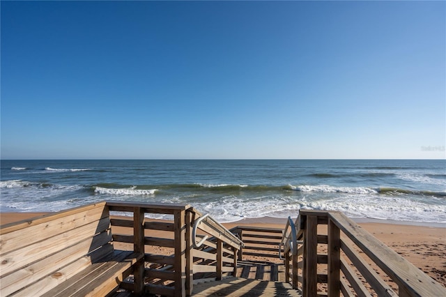 view of home's community with a beach view and a water view