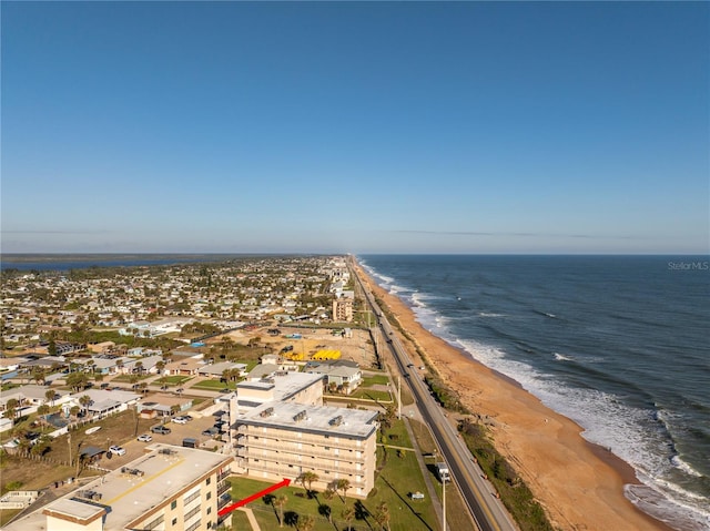 drone / aerial view featuring a water view and a beach view