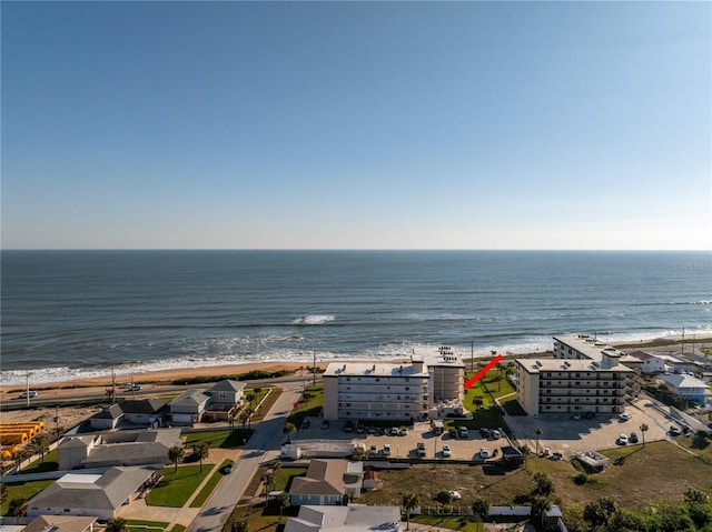 birds eye view of property with a water view and a view of the beach