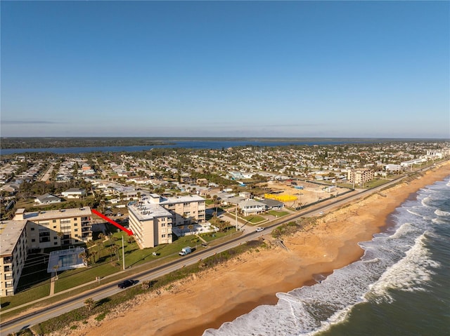 birds eye view of property featuring a water view and a view of the beach