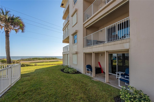 view of yard featuring a water view and a patio