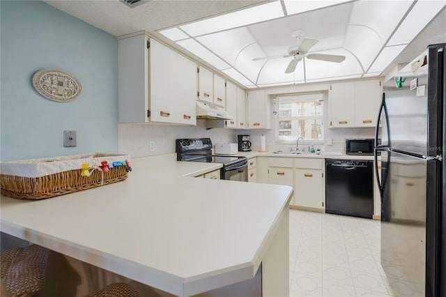 kitchen featuring kitchen peninsula, white cabinets, and black appliances