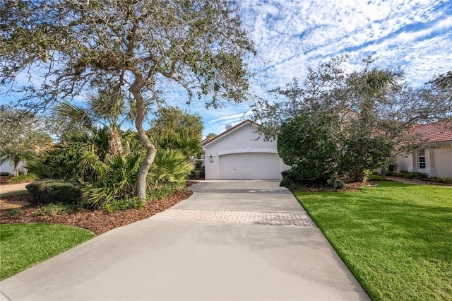 view of property hidden behind natural elements featuring a garage and a front yard