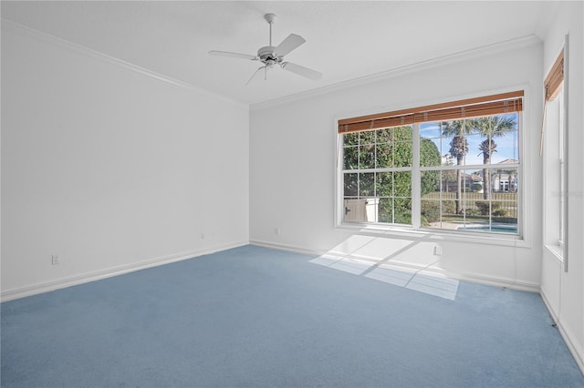 empty room featuring ceiling fan, carpet flooring, and crown molding