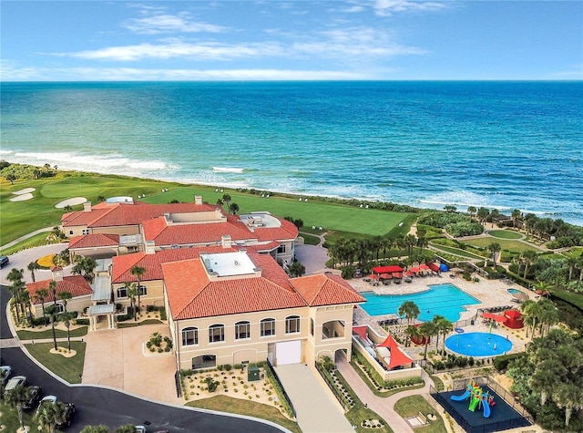 birds eye view of property with a beach view and a water view