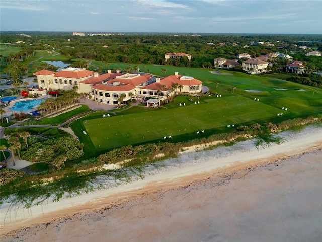 drone / aerial view featuring a beach view and a water view