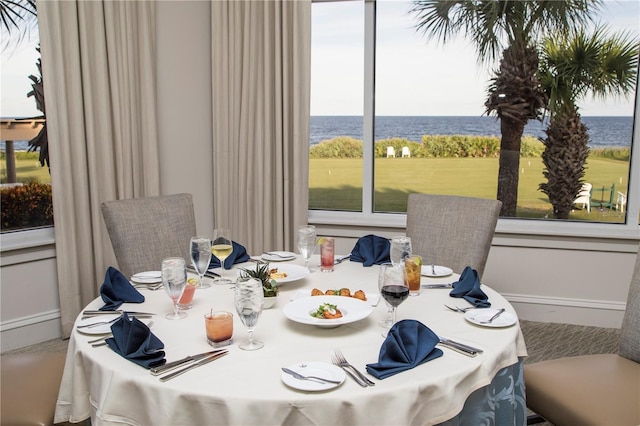 dining space featuring a water view