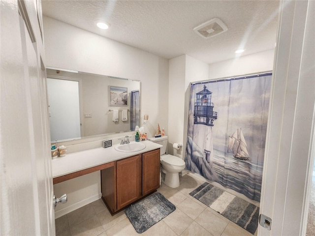 full bathroom with tile patterned floors, vanity, a textured ceiling, shower / bath combo with shower curtain, and toilet