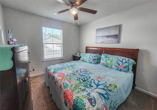 carpeted bedroom featuring ceiling fan and a textured ceiling