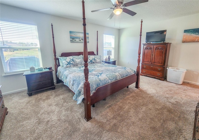 bedroom with multiple windows, ceiling fan, and light carpet