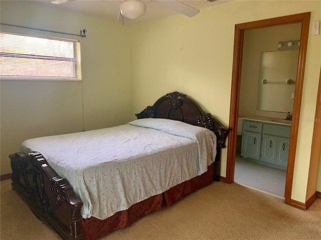 carpeted bedroom featuring ceiling fan and sink