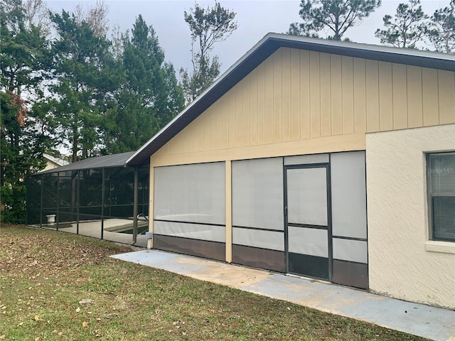 view of side of home featuring a lawn