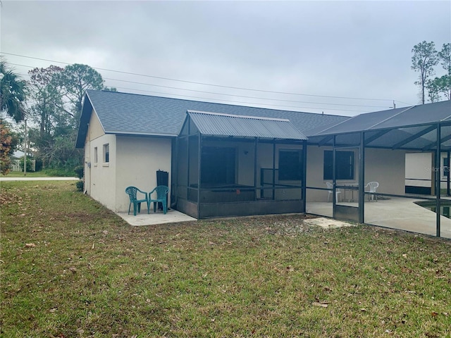 rear view of house with a lawn, a lanai, and a patio