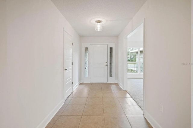 tiled entrance foyer with a textured ceiling