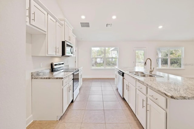 kitchen featuring a center island with sink, white cabinets, sink, light stone countertops, and appliances with stainless steel finishes