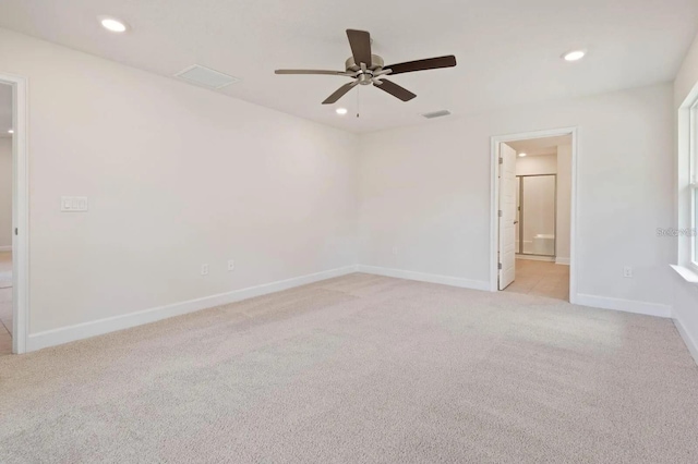 carpeted spare room featuring ceiling fan