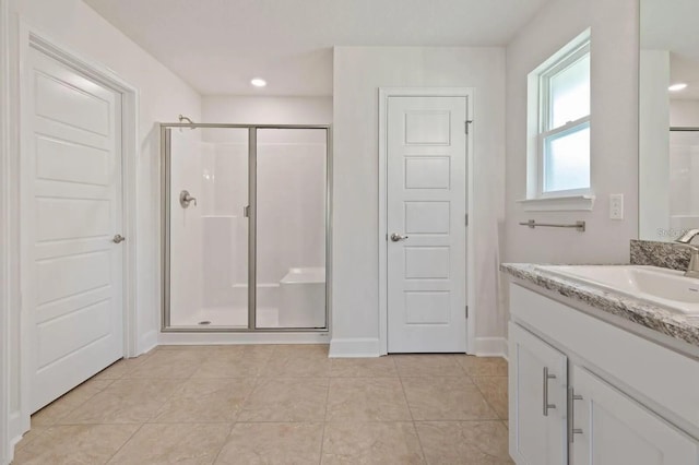 bathroom with tile patterned floors, vanity, and a shower with shower door