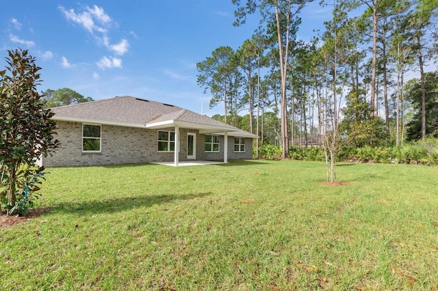 back of house with a yard and a patio area