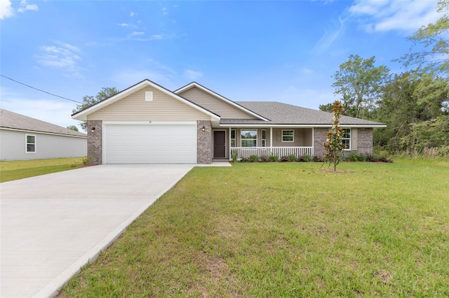 ranch-style home featuring covered porch, a garage, and a front yard