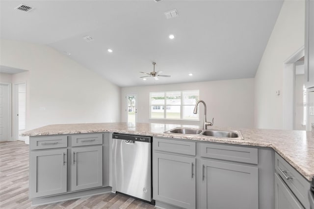 kitchen with lofted ceiling, sink, stainless steel dishwasher, ceiling fan, and hardwood / wood-style flooring