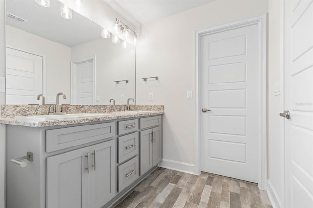 bathroom with vanity and hardwood / wood-style flooring