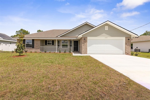 ranch-style house featuring concrete driveway, brick siding, a porch, a front lawn, and a garage