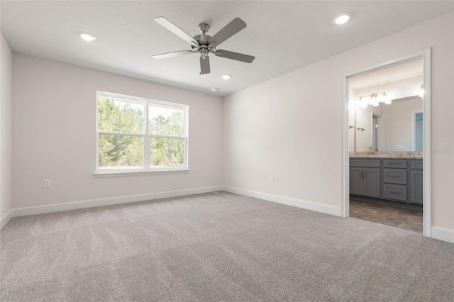 unfurnished bedroom featuring baseboards, ensuite bath, recessed lighting, and carpet floors
