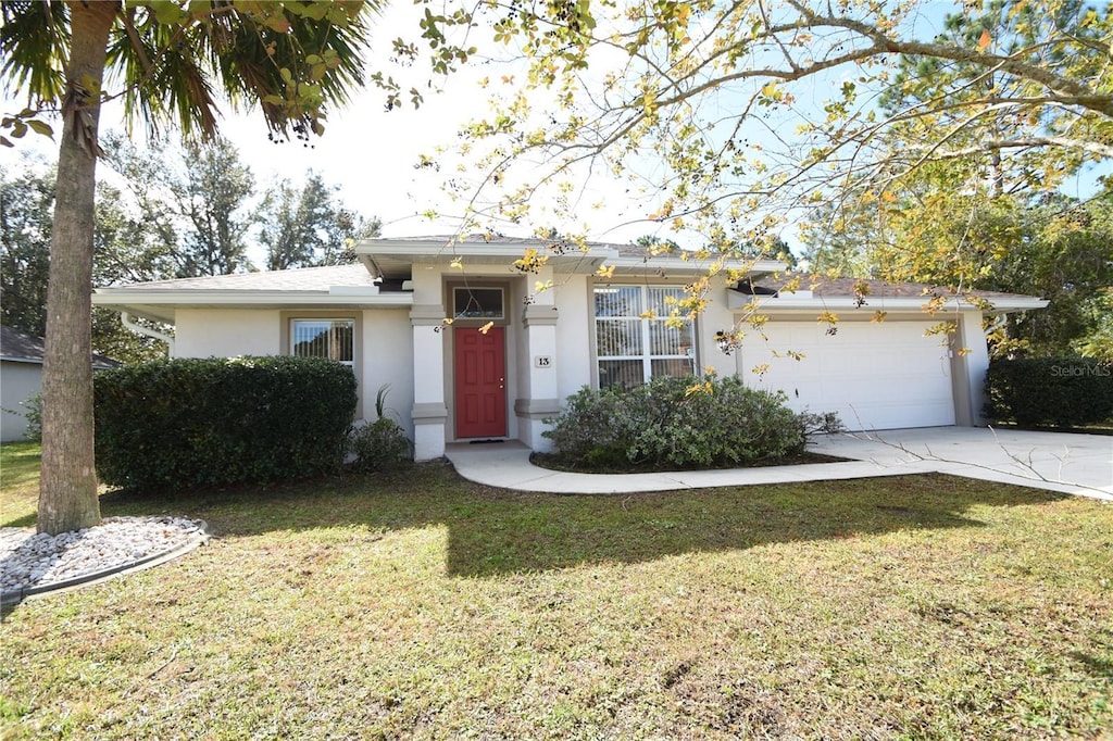 13 Bud Shire Ln, Palm Coast, FL 32137 - view of front of house with a garage and a front yard