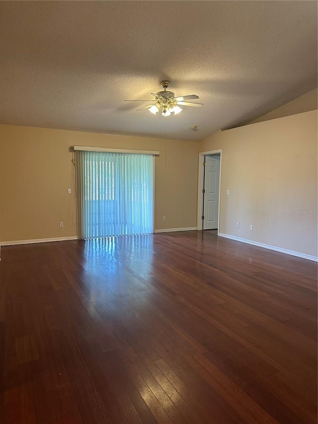 spare room featuring ceiling fan, dark wood-type flooring, and a textured ceiling