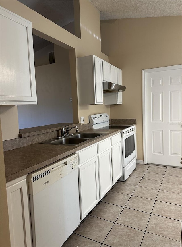 kitchen featuring white cabinetry, sink, a textured ceiling, white appliances, and light tile patterned floors