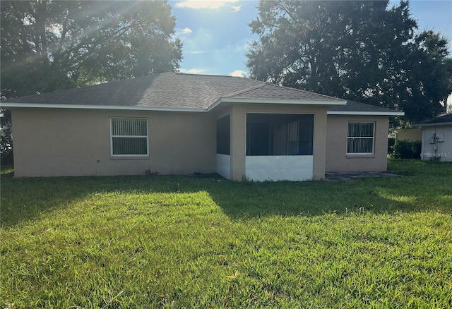 back of house with a lawn