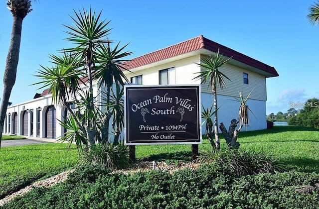 community / neighborhood sign with a lawn