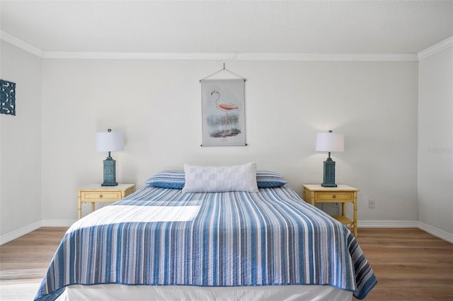 bedroom featuring hardwood / wood-style floors and ornamental molding