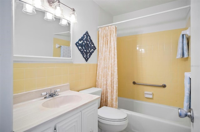 full bathroom with shower / tub combo, vanity, toilet, and tile walls