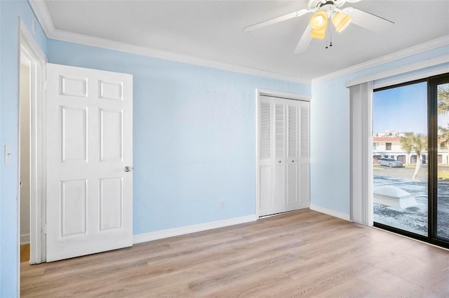 unfurnished bedroom featuring access to exterior, ceiling fan, crown molding, light hardwood / wood-style floors, and a closet