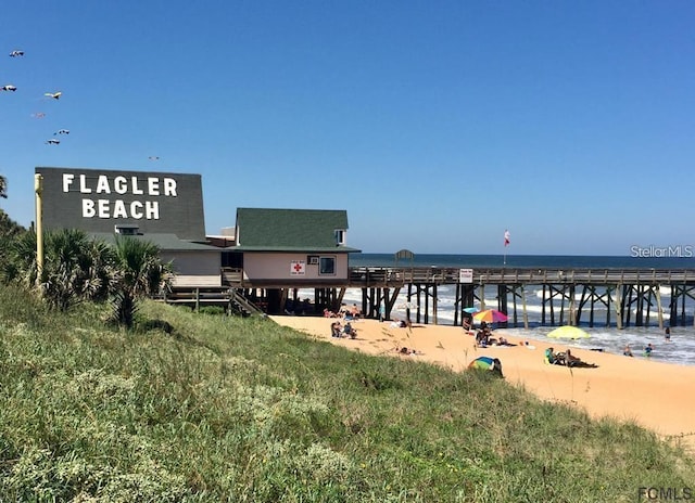 view of property's community featuring a beach view and a water view