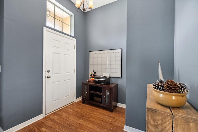 entrance foyer with a chandelier and hardwood / wood-style flooring