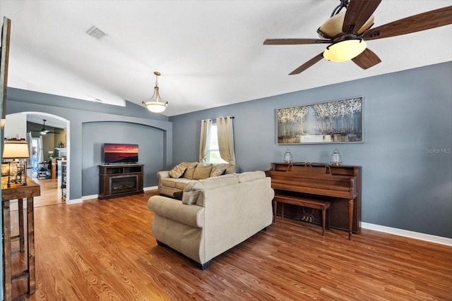 living room with hardwood / wood-style flooring and vaulted ceiling