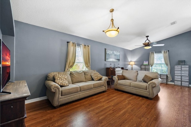 living room featuring ceiling fan, dark hardwood / wood-style flooring, and vaulted ceiling