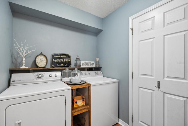 washroom featuring washer and clothes dryer and a textured ceiling