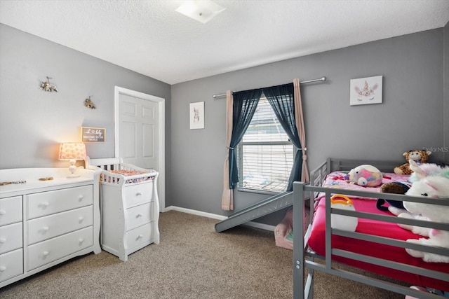 bedroom featuring light carpet and a textured ceiling