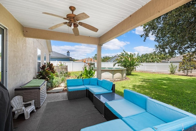 view of patio featuring outdoor lounge area, a fenced in pool, and ceiling fan