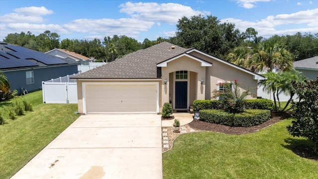 view of front of house with a garage and a front lawn