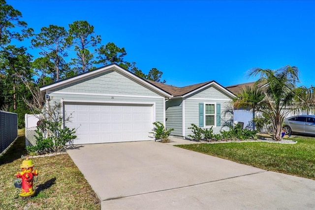 single story home featuring a garage and a front lawn