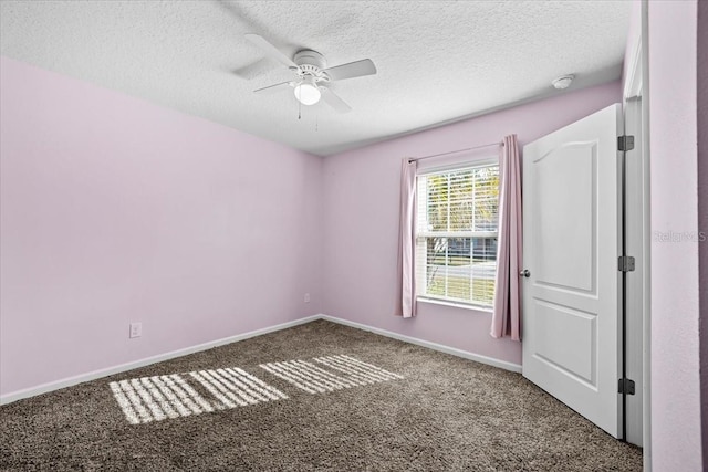 spare room with carpet floors, a textured ceiling, and ceiling fan