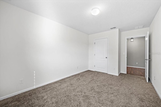 unfurnished bedroom with carpet and a textured ceiling